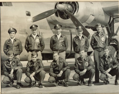 Bill Gleason and his crew with plane from WWII
